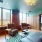 a lounge with a large window chairs and a couch
