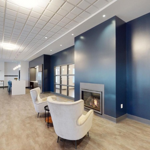 A perfect fit for the whole family a room with chairs and a fireplace