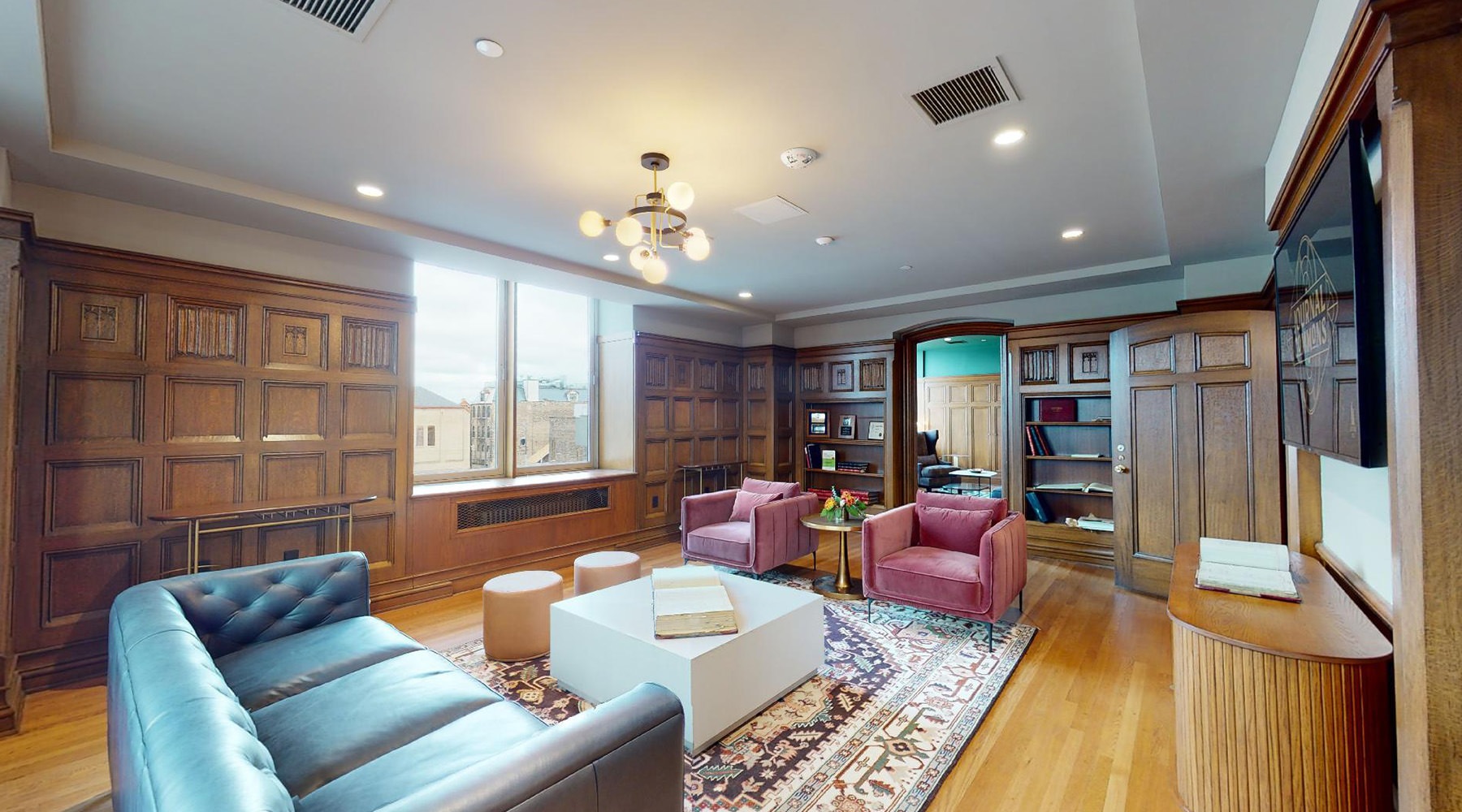 a large lounge with seating and a table