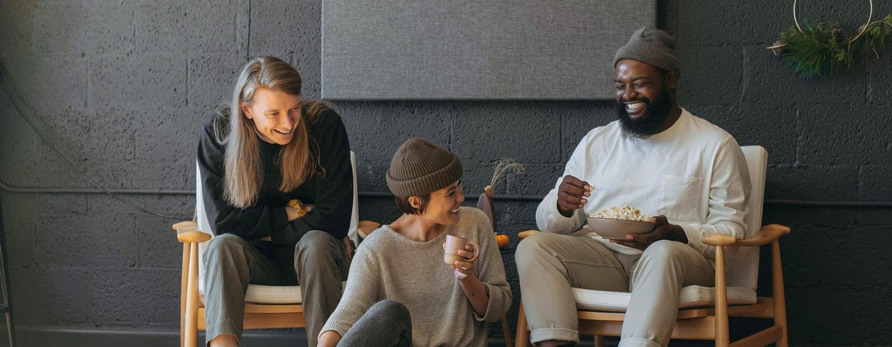 friends sit together around an open laptop