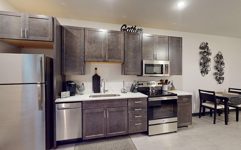 a kitchen with stainless steel appliances and wood cabinets