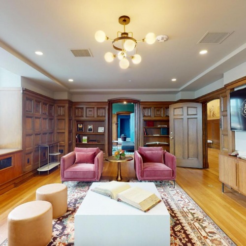 Settle into comfort at Journal Commons a lounge with seating table tv and a large window